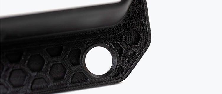 A black 3D-printed airduct frame made in PC-ABS using fused deposition modeling.