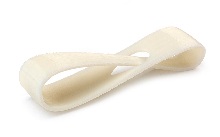 An off-white 3D-printed loop made from ABS-M30i using fused deposition modeling, with a normal finish.